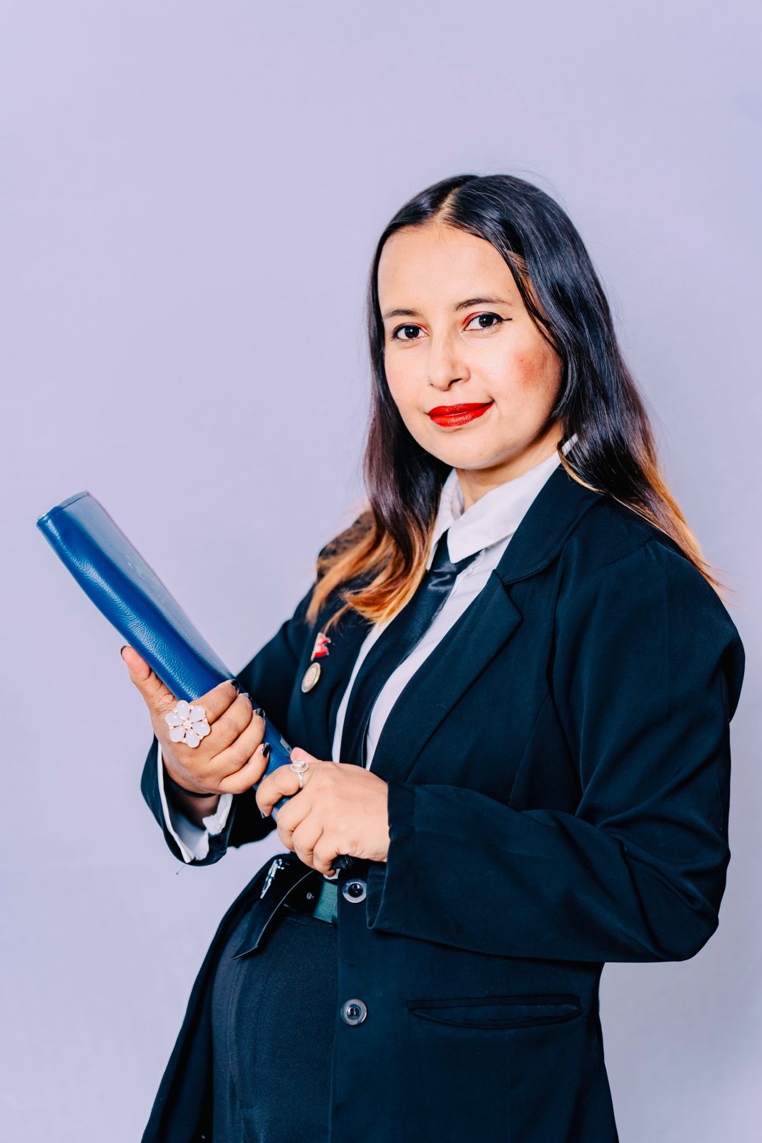 Advocate Suraksha Acharya, confident portrait with arms crossed.