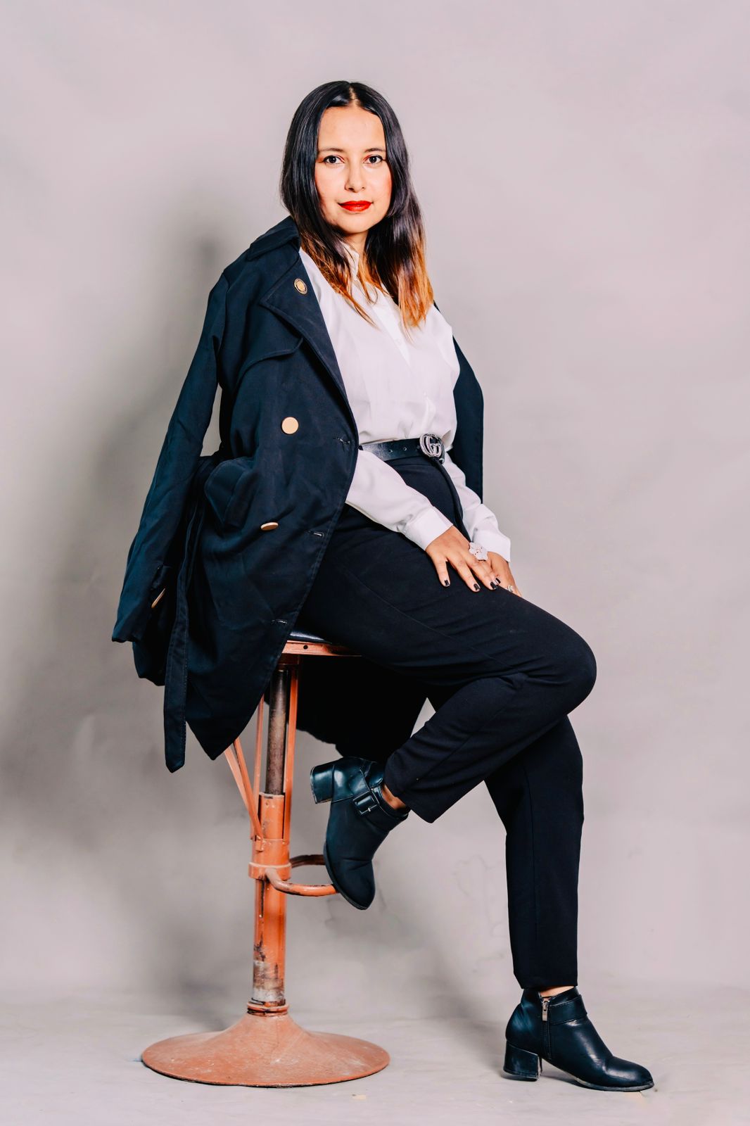 Advocate Suraksha Acharya seated for a professional portrait.