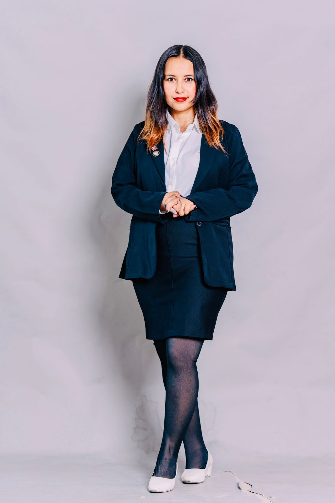 Advocate Suraksha Acharya, professional outdoor portrait next to a car.