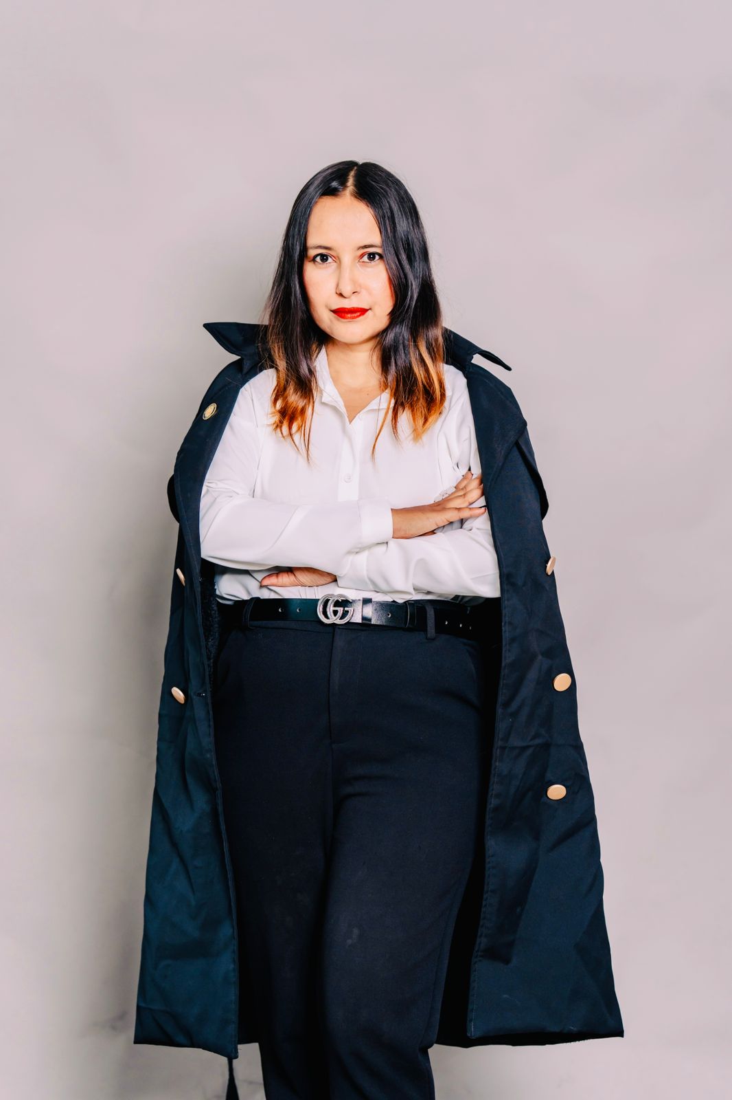 Advocate Suraksha Acharya holding a blue legal file.